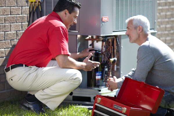 HVAC Technician Explaining AC Maintenance to Customer in Houston, TX